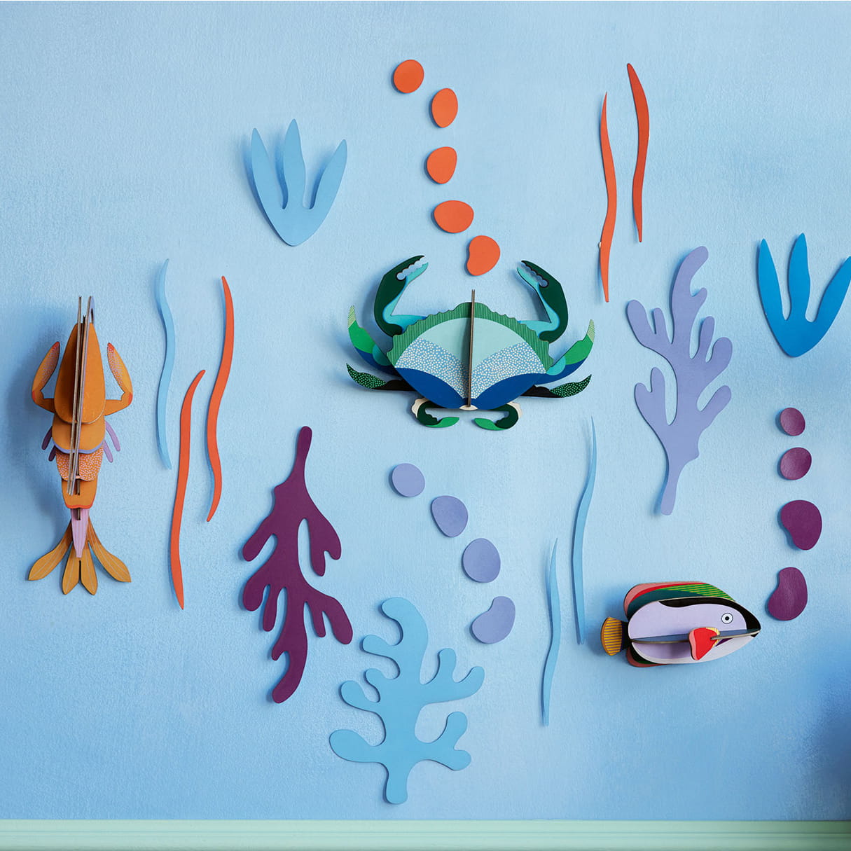 ocean themed wall decor with crab, shrimp and tropical fish by studio roof.