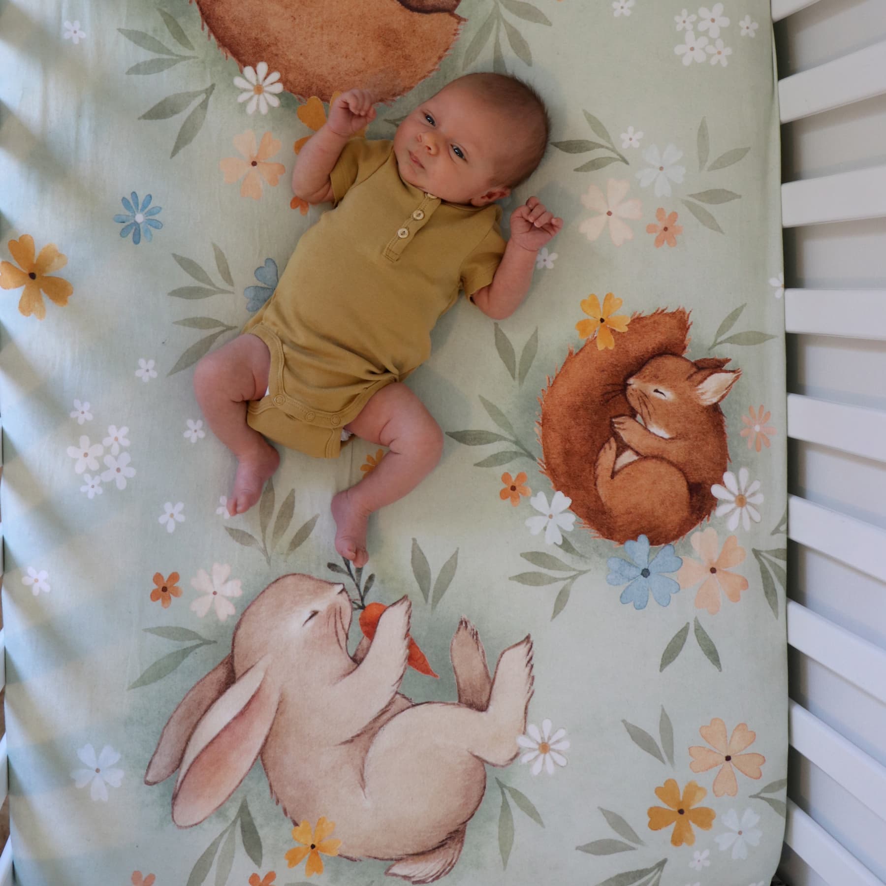 Rookie Humans crib sheet Enchanted Meadow. Floral crib sheet with sleeping bear, squirrel, hedgehog and bunny. Light green crib sheet, woodland theme, floral theme. Boho nursery, floral nursery, boho crib sheet, boho baby.