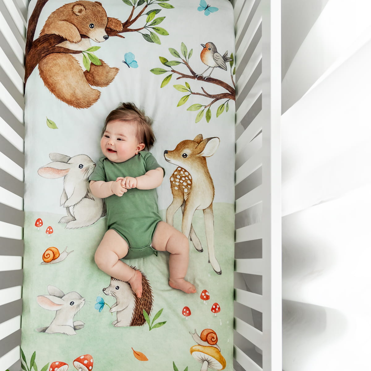 Watercolor woodland crib sheet featuring bear bird butterfly bunny dawn deer hedgehog and mushrooms