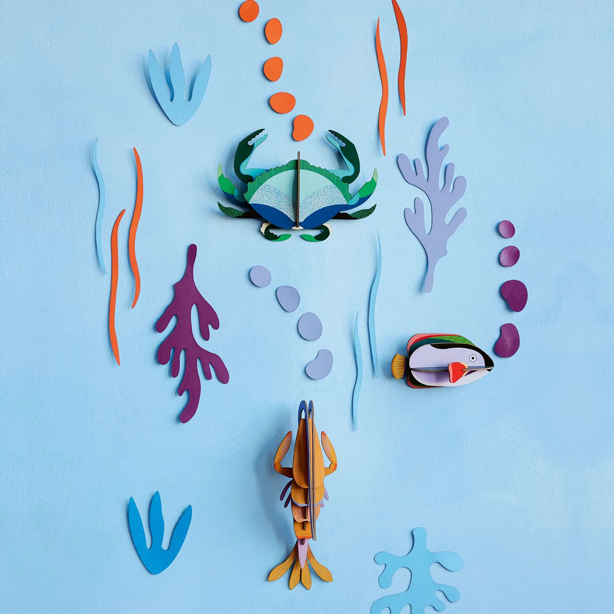 ocean themed wall decor with crab, shrimp and tropical fish by studio roof.
