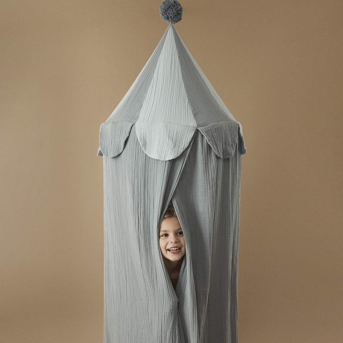 Kids cotton bed canopy in blue with pompom