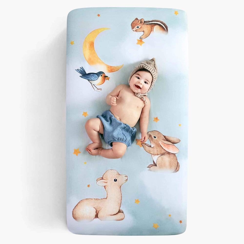 Rookie Humans crib sheet Goodnight Wonderland, fitted crib sheet with llama bunny bird moon stars and chipmunk. Light blue crib sheet with clouds. 
