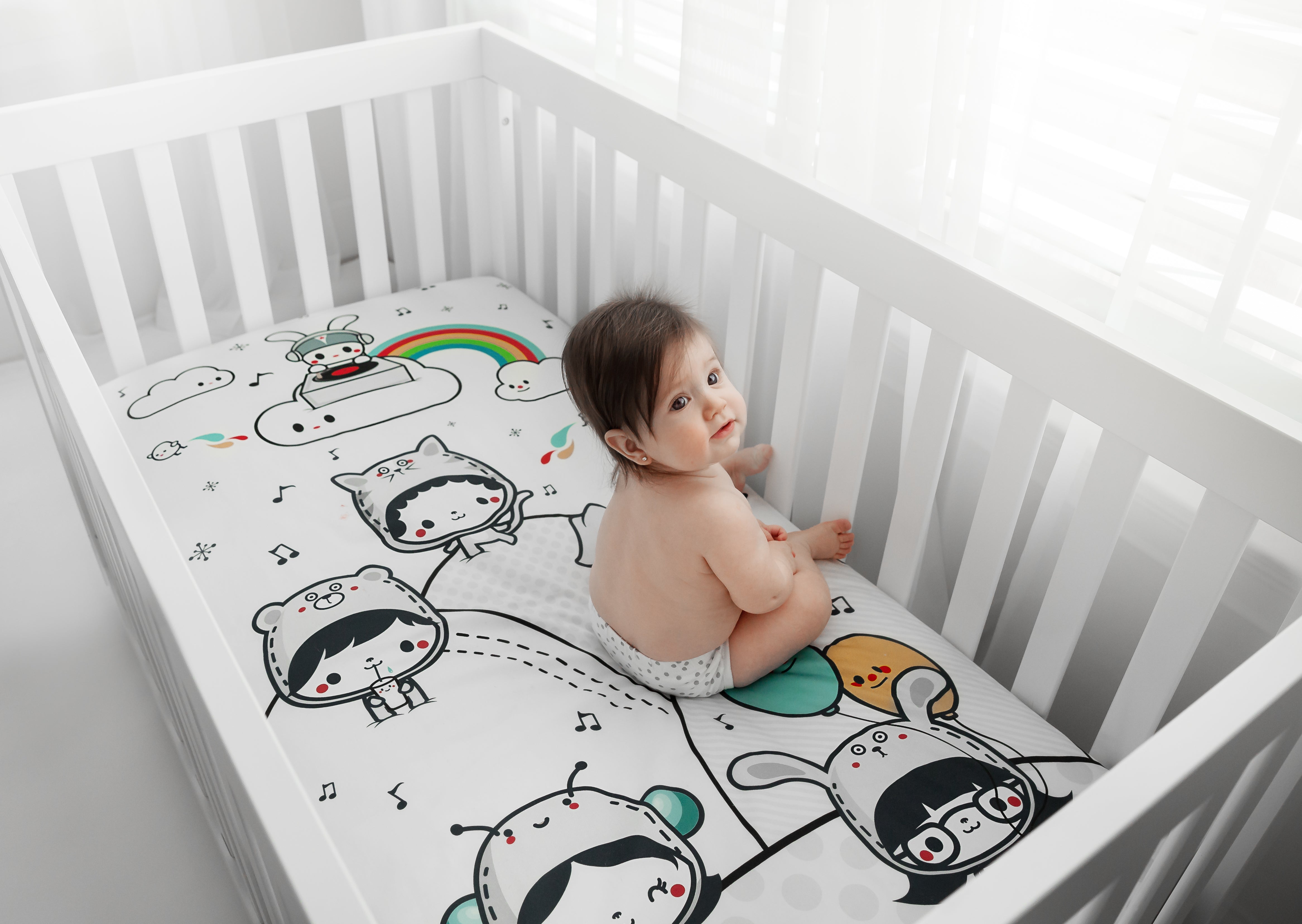 Fitted baby crib sheet by Rookie Humans, Party In My Crib. Illustrated by Elisa Sassi. Designed for the modern nursery, packaged to make a unique baby shower gift. 