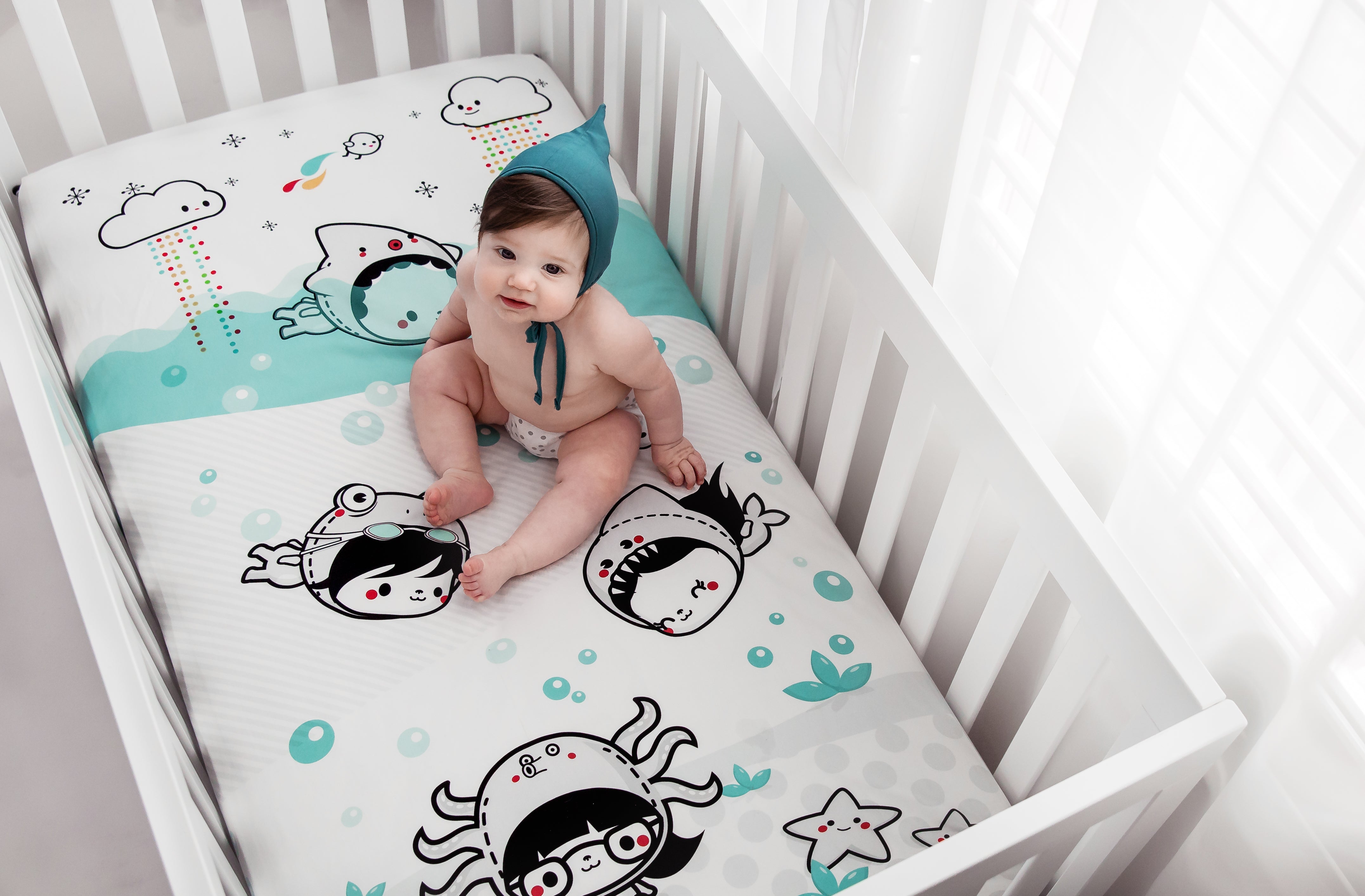 Fitted baby crib sheet by Rookie Humans, Dive In. Illustrated by Elisa Sassi. Designed for the modern nursery, packaged to make a unique baby shower gift. 