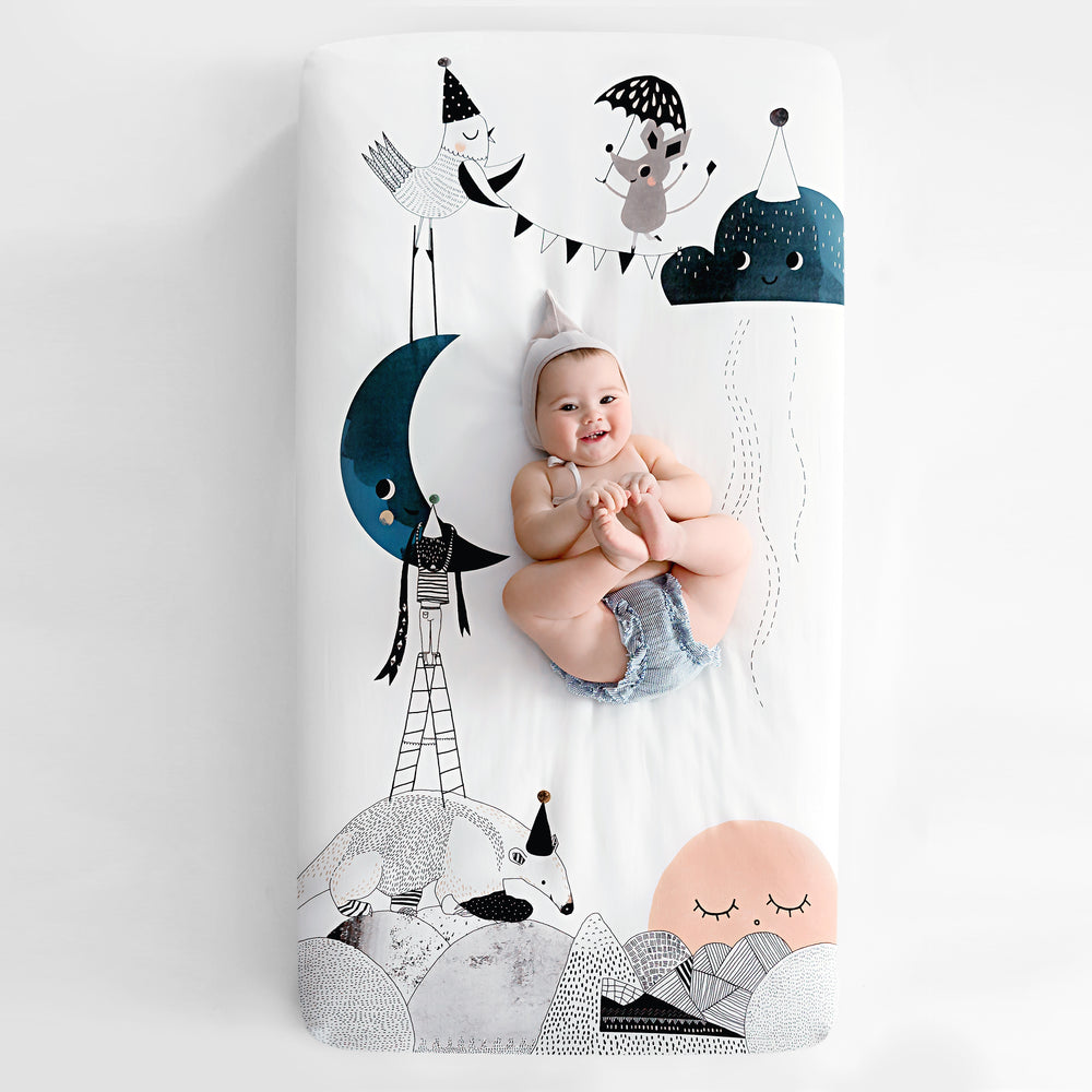 Fitted baby crib sheet by Rookie Humans, The Moon's Birthday. Illustrated by Swanjte Hinrichsen. Designed for the modern nursery, packages to make a unique baby shower gift.