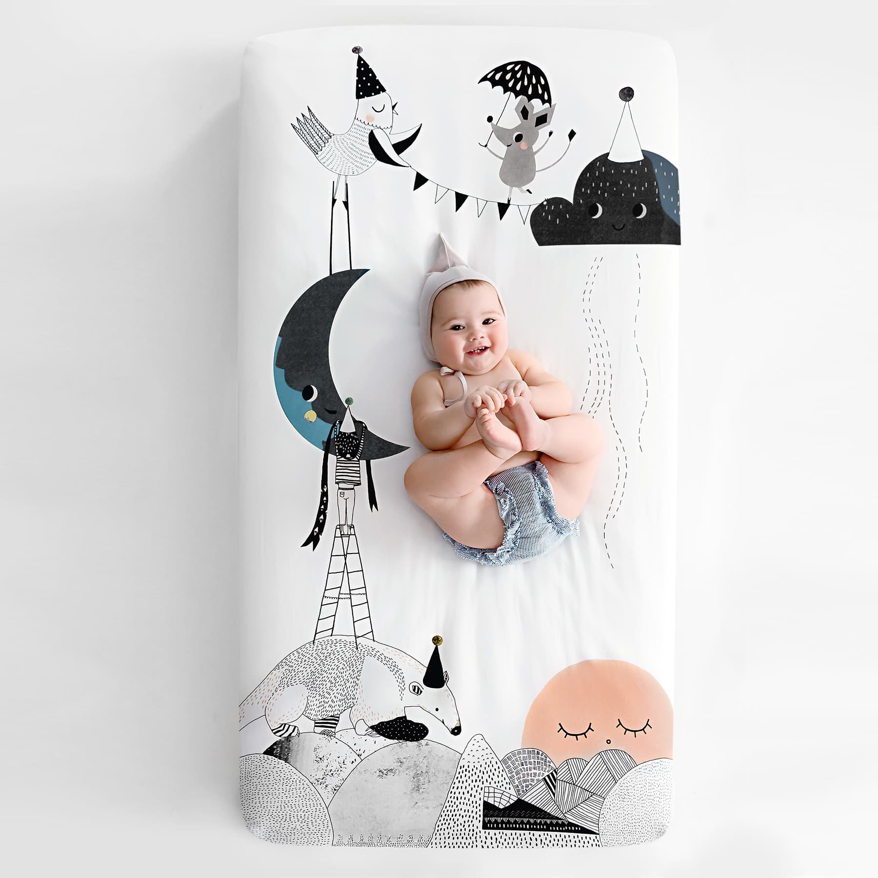 Fitted baby crib sheet by Rookie Humans, The Moon's Birthday. Illustrated by Swanjte Hinrichsen. Designed for the modern nursery, packages to make a unique baby shower gift.