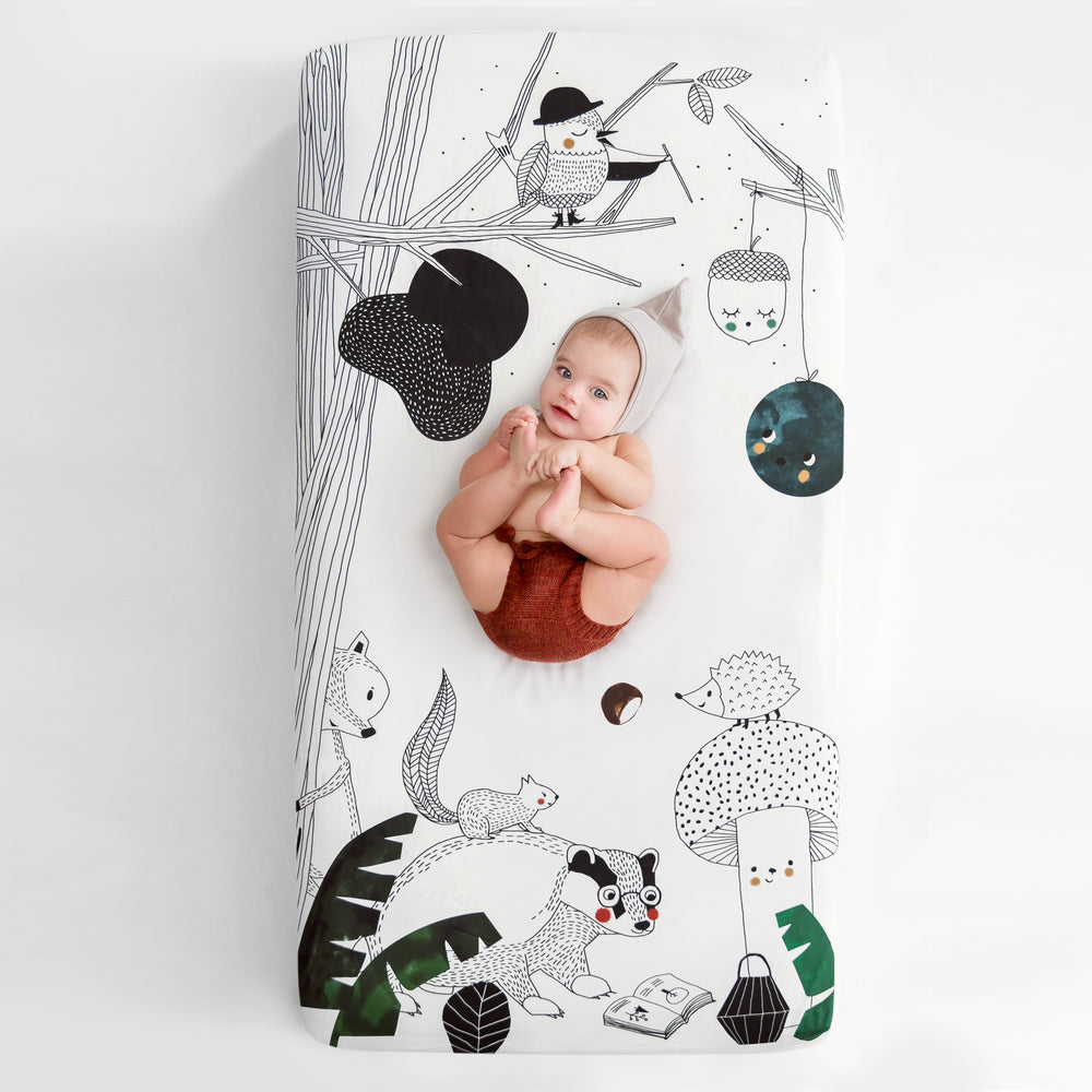 Fitted baby crib sheet by Rookie Humans, Woodland Dreams. Illustrated by Swanjte Hinrichsen. Designed for the modern nursery, packaged to make a unique baby shower gift. Woodland nursery theme.