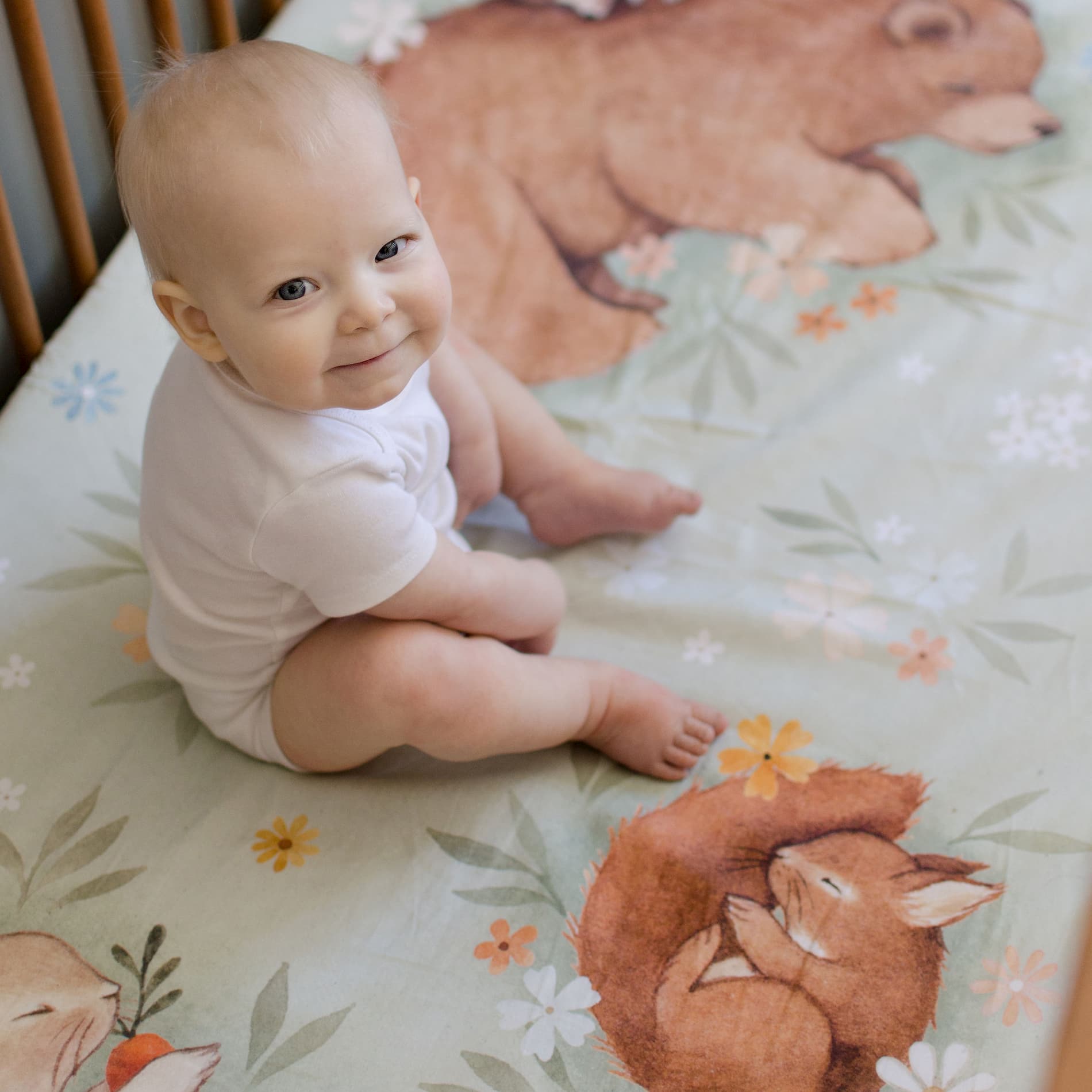 Rookie Humans crib sheet Enchanted Meadow. Floral crib sheet with sleeping bear, squirrel, hedgehog and bunny. Light green crib sheet, woodland theme, floral theme.