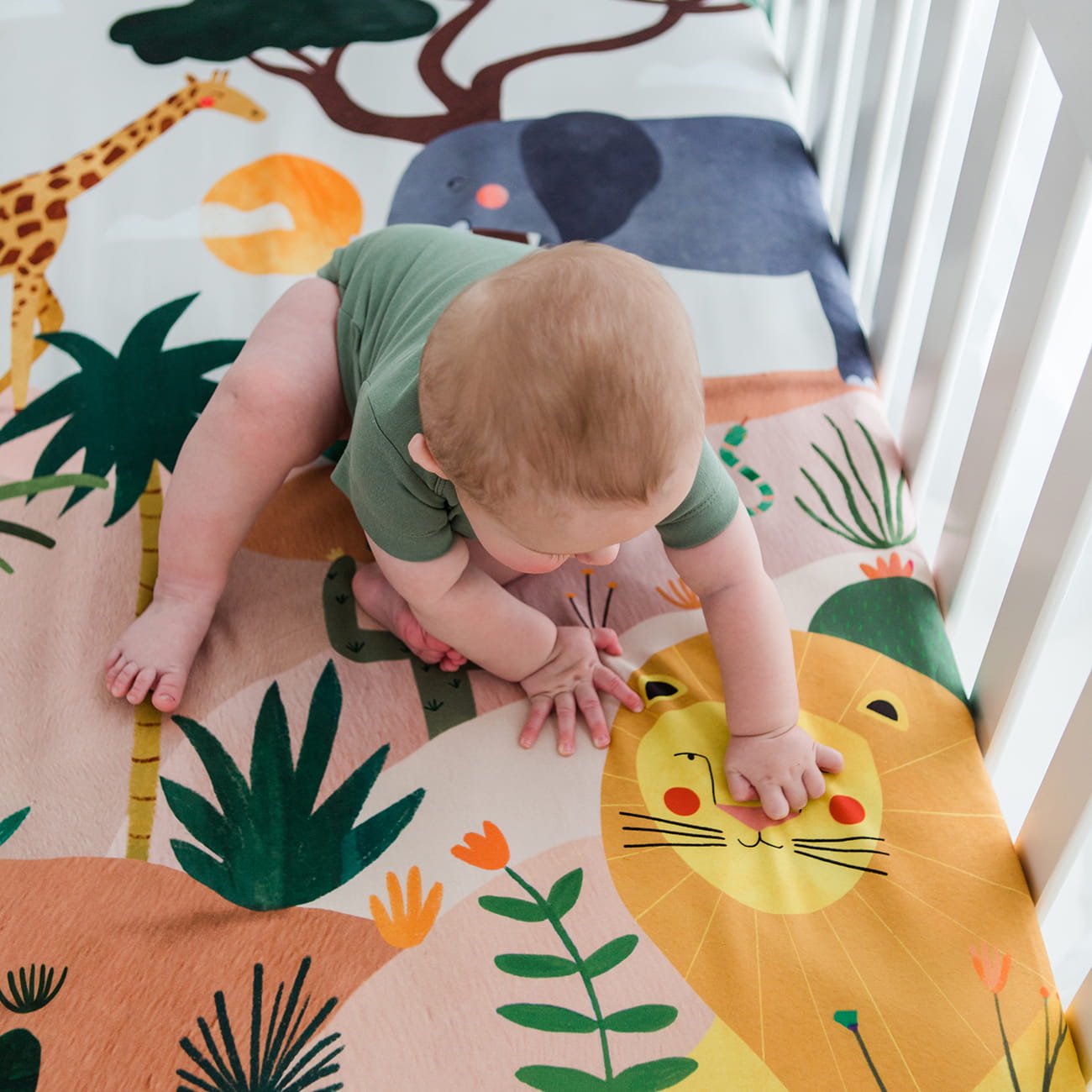 In the savanna crib sheet, safari elephant giraffe lion 