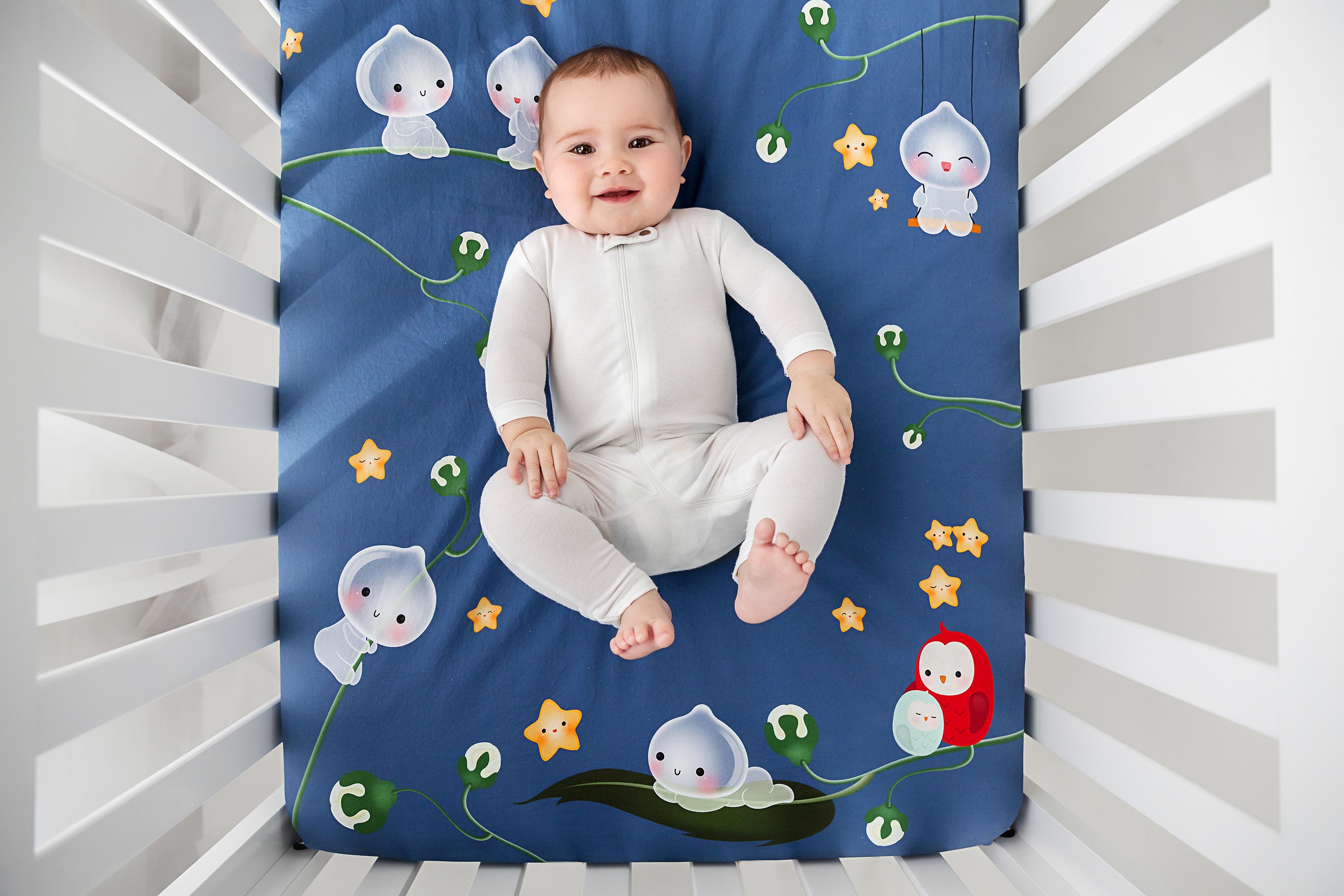 Fitted baby crib sheet by Rookie Humans, Magic Forest. Illustrated by Silvia Portella. Designed for the modern nursery, navy crib sheet.
