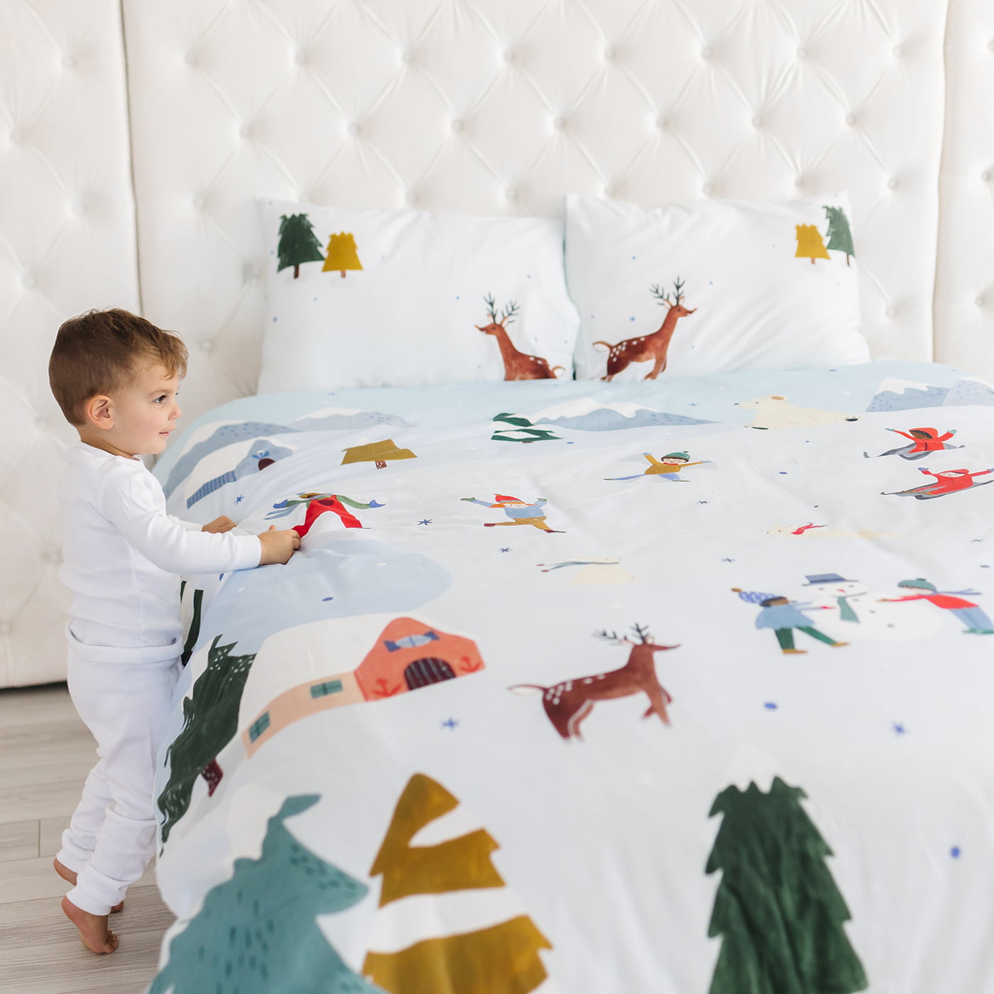 Snowy day holiday christmas winter themed bedding in twin full and queen size. Features snowy mountains, reindeer, arctic bunnies, snowmen and polar bear. Christmas bedding set, Christmas duvet.