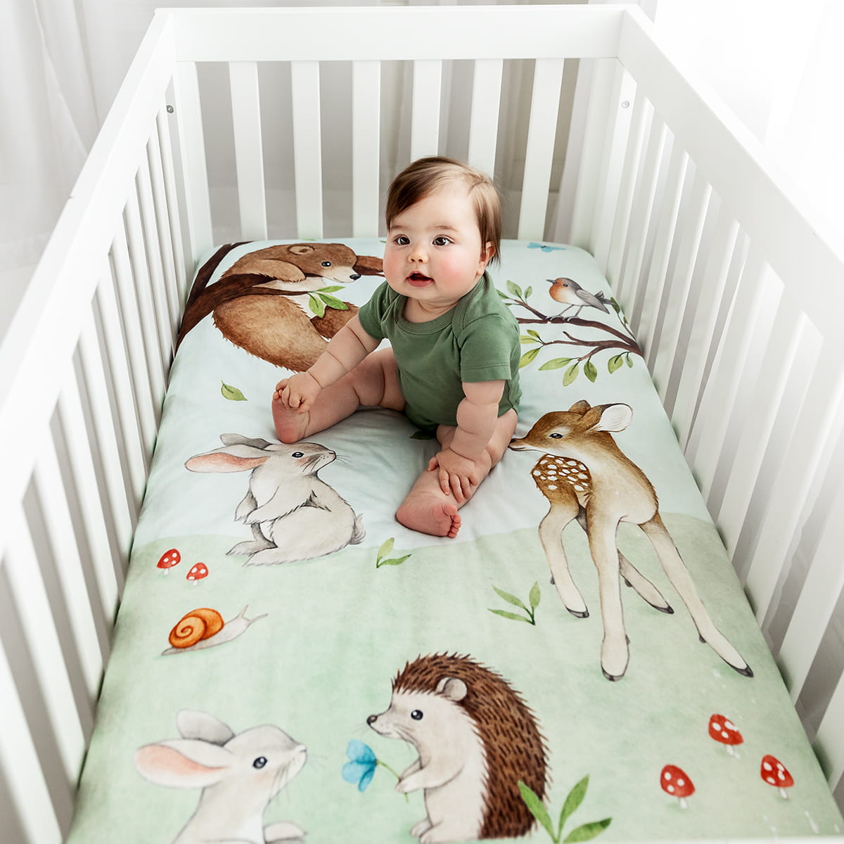 Watercolor woodland crib sheet featuring bear bird butterfly bunny dawn deer hedgehog and mushrooms