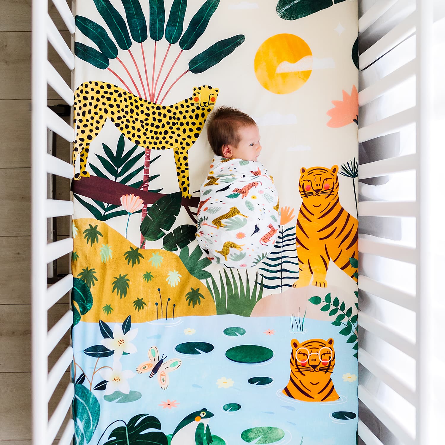 jungle crib sheet and matching jungle swaddle print. Pattern includes cheetahs, tigers and wild vegetation. Perfect addition to a jungle nursery or safari nursery.