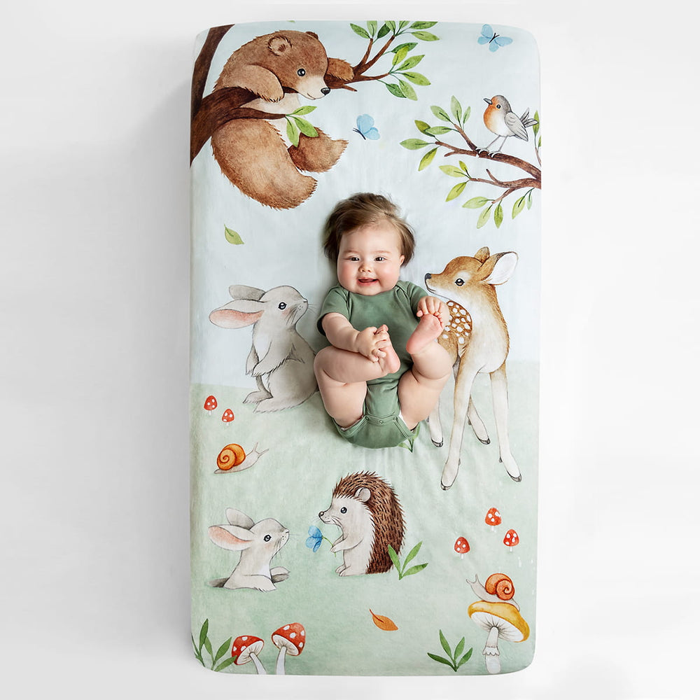 Watercolor woodland crib sheet featuring bear bird butterfly bunny dawn deer hedgehog and mushrooms